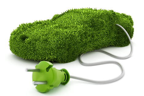 Green car covered with grass texture connected to the electric plug